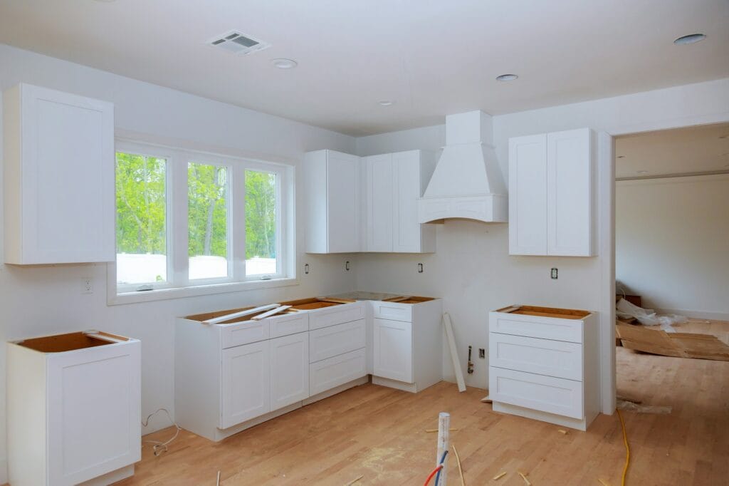 Interior design construction of kitchen with cabinet maker installing custom